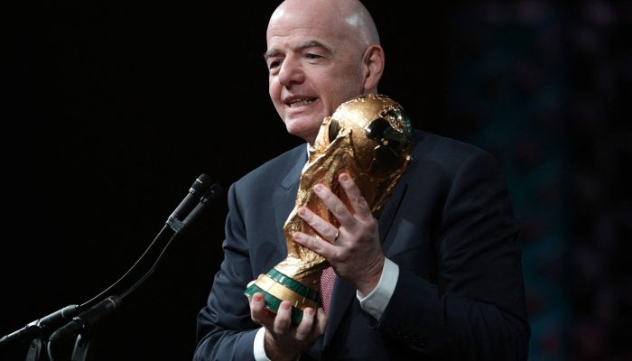 Gianni Infantino discursa com troféu da Copa do Mundo durante evento em Washington, nos EUA 
             -       
        Alex Wong - 29.jan.26/Getty Images via AFP