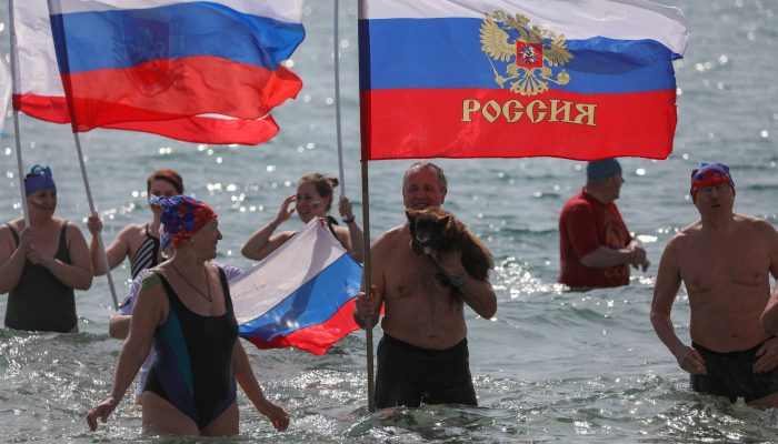 Membros de um clube de natação comemoram aniversário da anexação da Crimeia pela Rússia na cidade de Yevpatoriya, na região do Mar Negro
             -       
        Alexey Pavlishak - 18.mar.26/Reuters